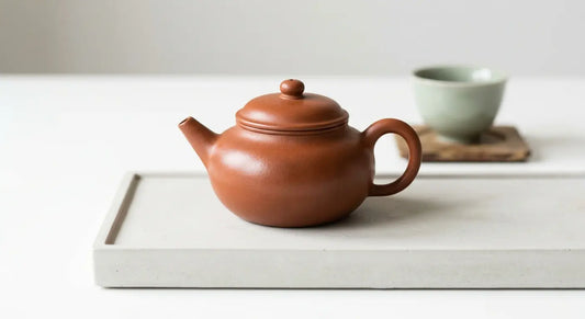 Seasoned Yixing clay teapot with natural patina finish.